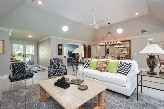 a living room with furniture and a view of kitchen