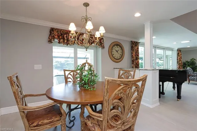 a view of a dining room with furniture and chandelier