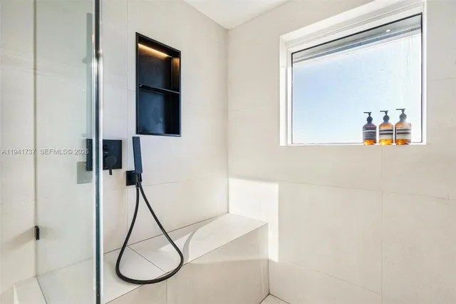 a picture of a bathroom with a shower and a mirror