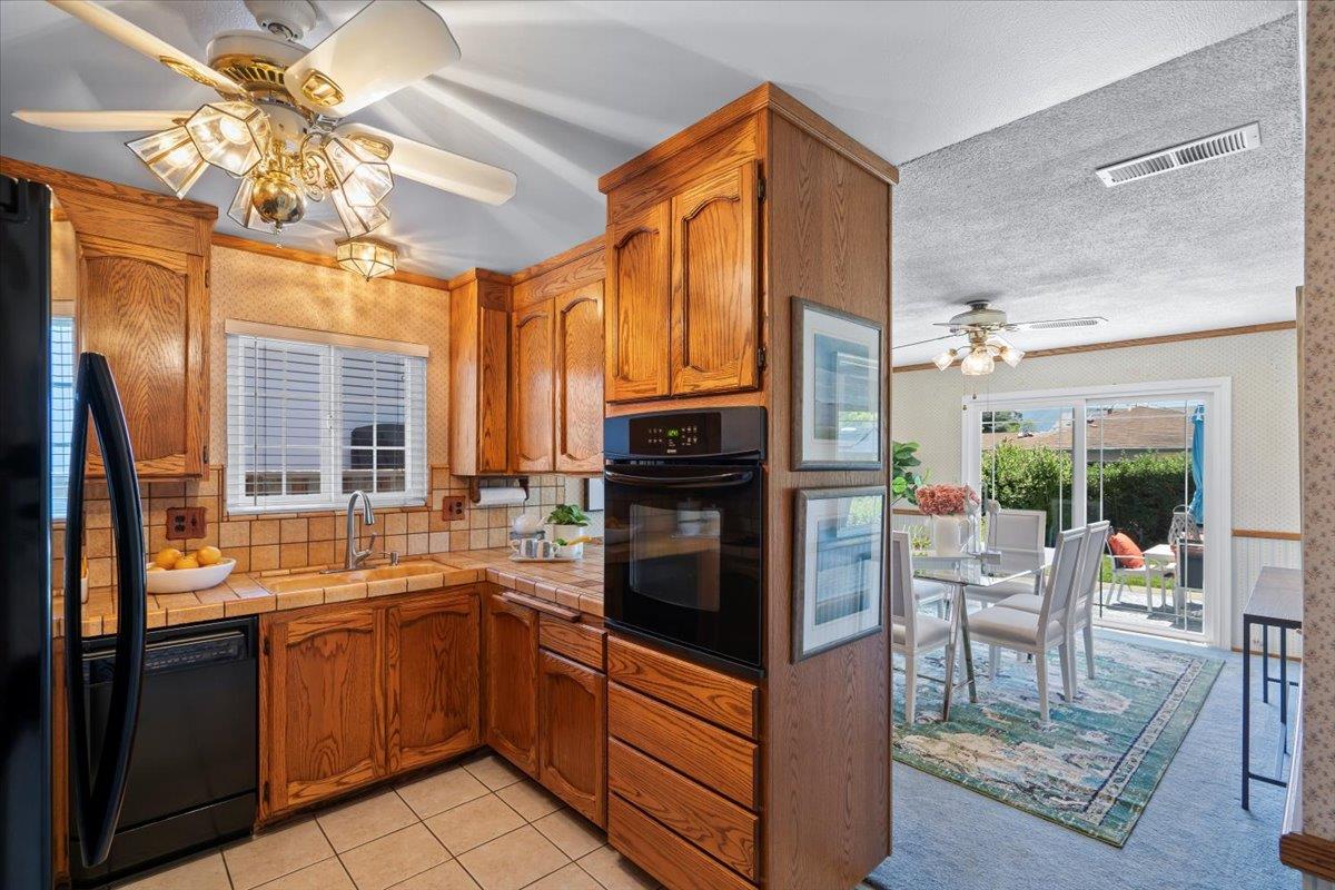 1470 Inskip Drive Campbell, CA 95008 - Photo 14 of 43 a kitchen with stainless steel appliances granite countertop a refrigerator a sink dishwasher a stove and a dining table with wooden floor