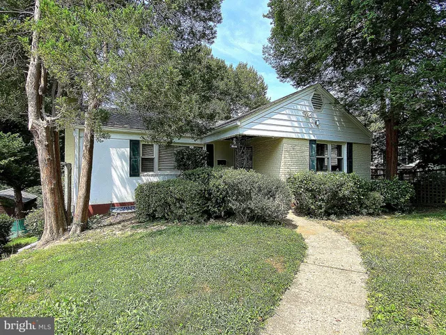 a front view of house with yard and trees