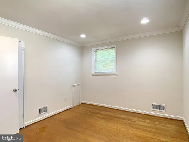 a bathroom with a bathtub shower sink mirror and toilet