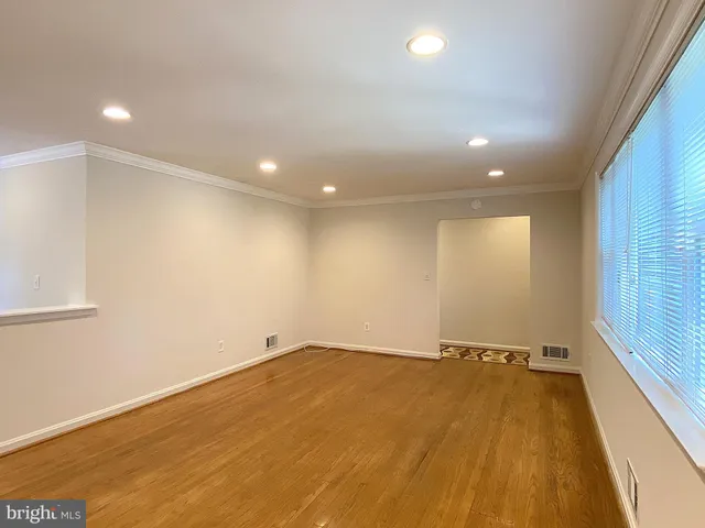 a room with pool table and windows