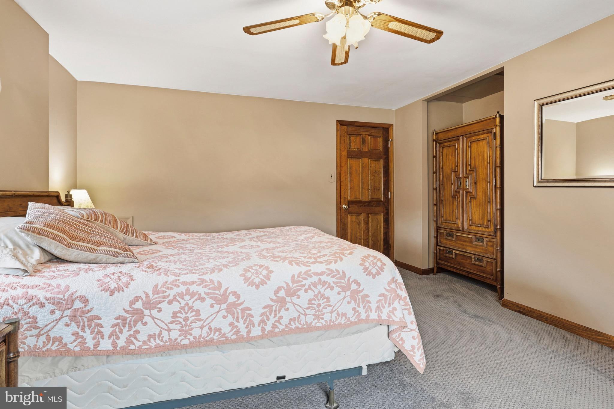 527 Saxer Avenue Springfield, PA 19064 - Photo 20 of 33 a bedroom with a large bed and a chandelier