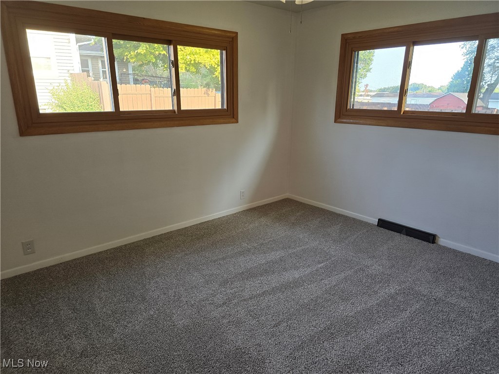 67 Moore Road Akron, OH 44319 - Photo 7 of 15 Empty room with plenty of natural light and carpet floors