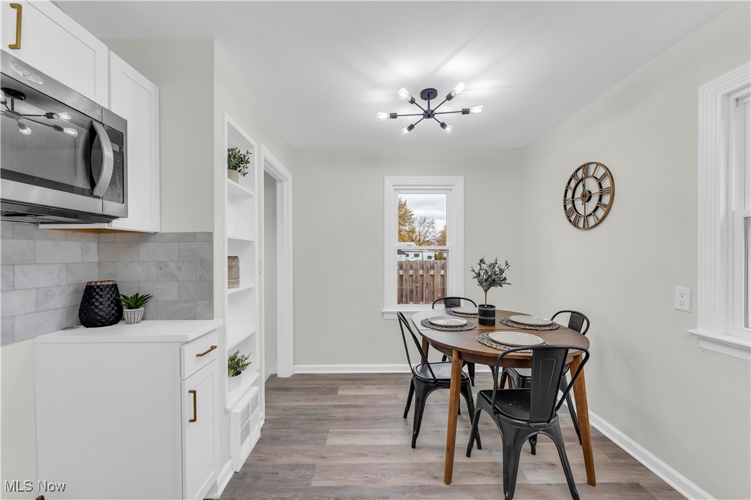 28920 Ridge Road Wickliffe, OH 44092 - Photo 11 of 27 Dining room with light wood-type flooring and a notable chandelier