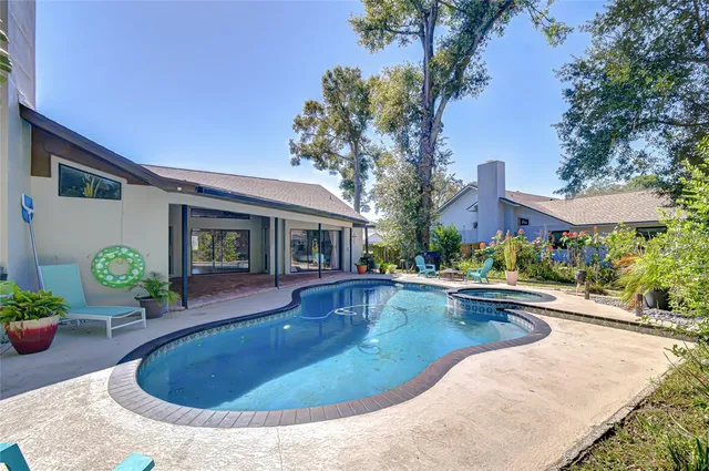 a view of swimming pool with outdoor seating