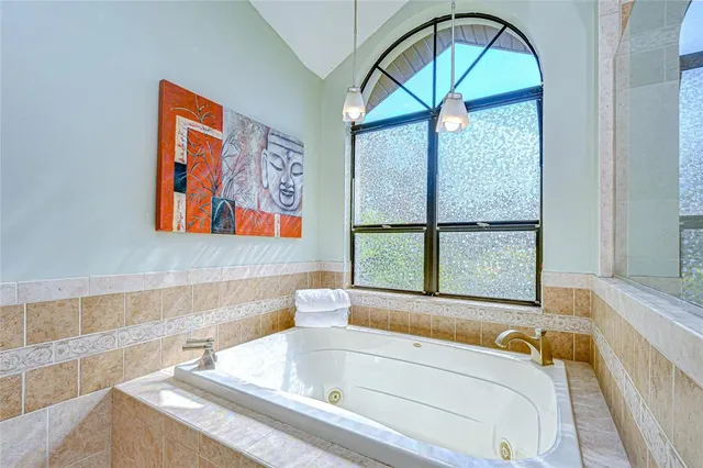 a bathroom with a tub and a window