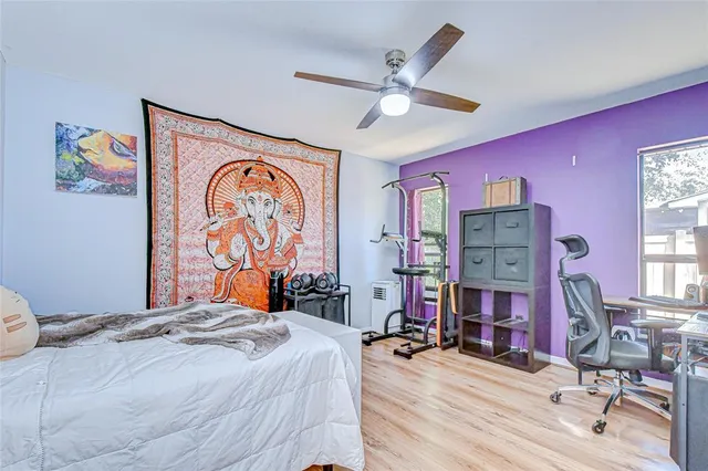 a bedroom with bed and a chandelier