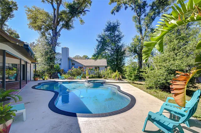 a view of a swimming pool with lounge chair