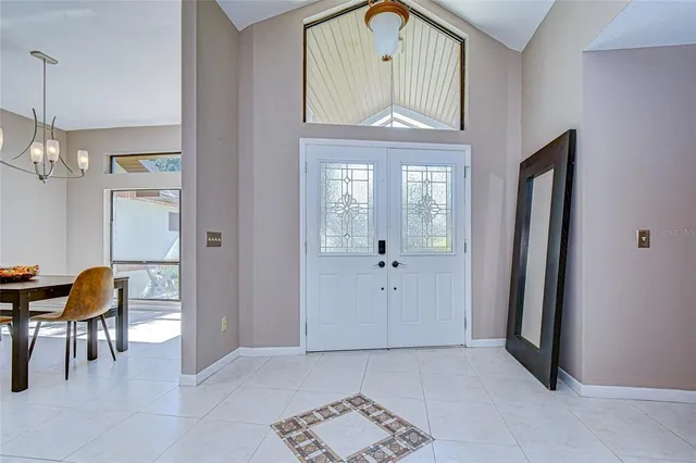 a view of a hallway with entryway and dining room view