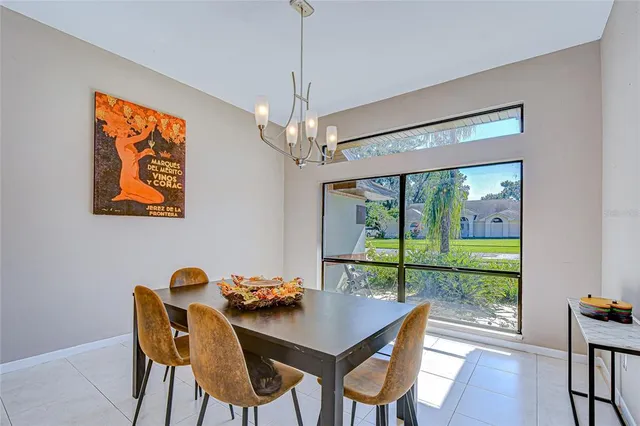a view of a dining room with furniture large window and wooden floor