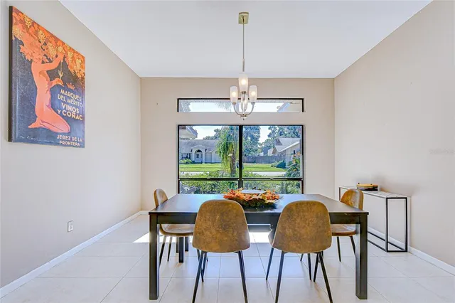 a view of a dining room with furniture a chandelier and wooden floor