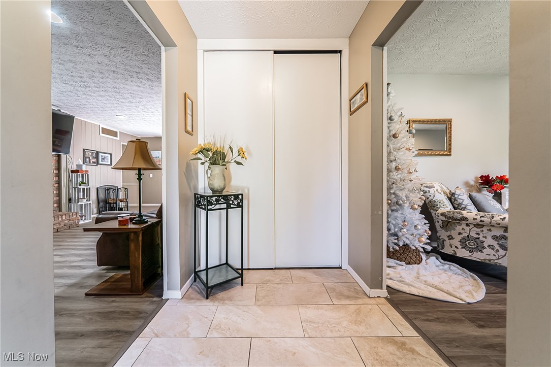 10794 Waterfall Road Strongsville, OH 44149 - Photo 5 of 37 Entryway with a textured ceiling and light wood-style flooring