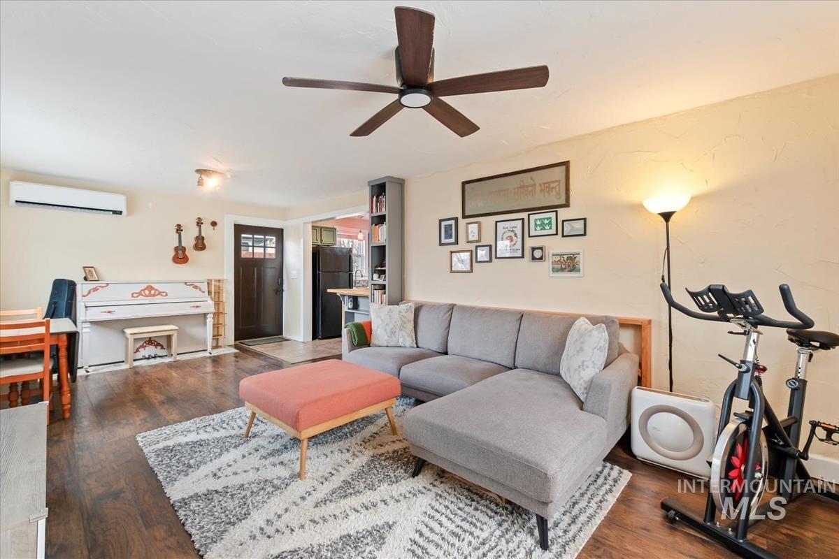 2837 Ona Street Boise, ID 83705 - Photo 13 of 26 Living room with dark wood-type flooring, an AC wall unit, ceiling fan, and a baseboard radiator
