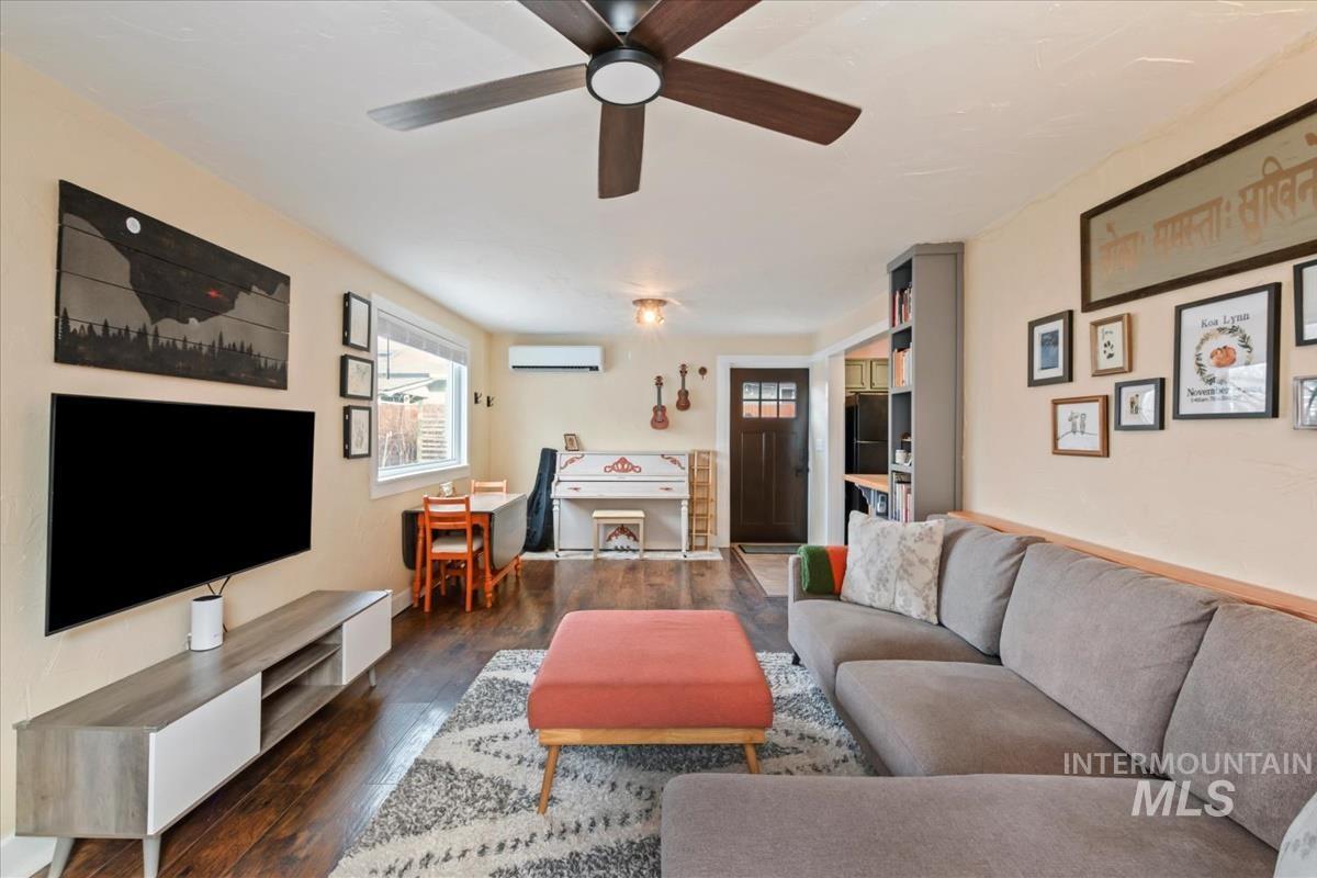2837 Ona Street Boise, ID 83705 - Photo 14 of 26 Living room with healthy amount of natural light, dark wood finished floors, a ceiling fan, and a wall unit AC