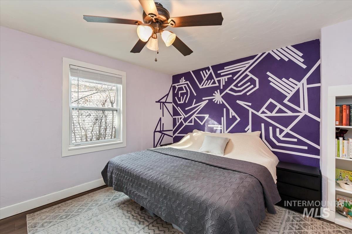 2837 Ona Street Boise, ID 83705 - Photo 19 of 26 Bedroom featuring an accent wall, wood finished floors, and ceiling fan