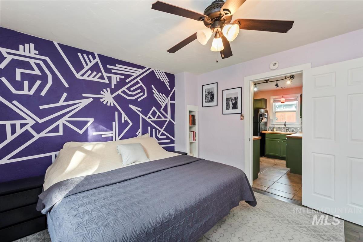 2837 Ona Street Boise, ID 83705 - Photo 20 of 26 Bedroom with an accent wall, ceiling fan, light tile patterned flooring, freestanding refrigerator, and ensuite bath