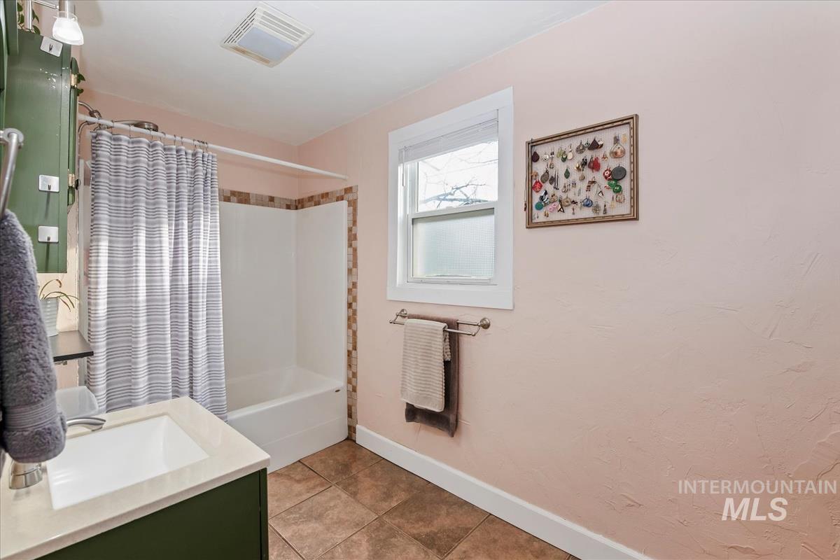 2837 Ona Street Boise, ID 83705 - Photo 21 of 26 Full bathroom featuring shower / tub combo with curtain, vanity, and light tile patterned flooring