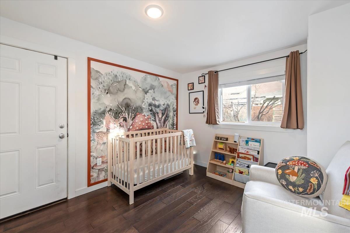 2837 Ona Street Boise, ID 83705 - Photo 23 of 26 Bedroom with a crib and dark wood-type flooring