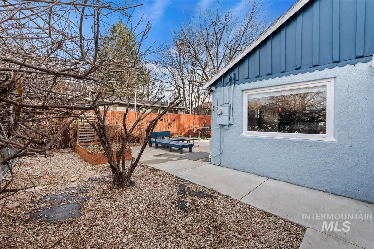 2837 Ona Street Boise, ID 83705 - Photo 4 of 26 View of side of home with board and batten siding and a patio area