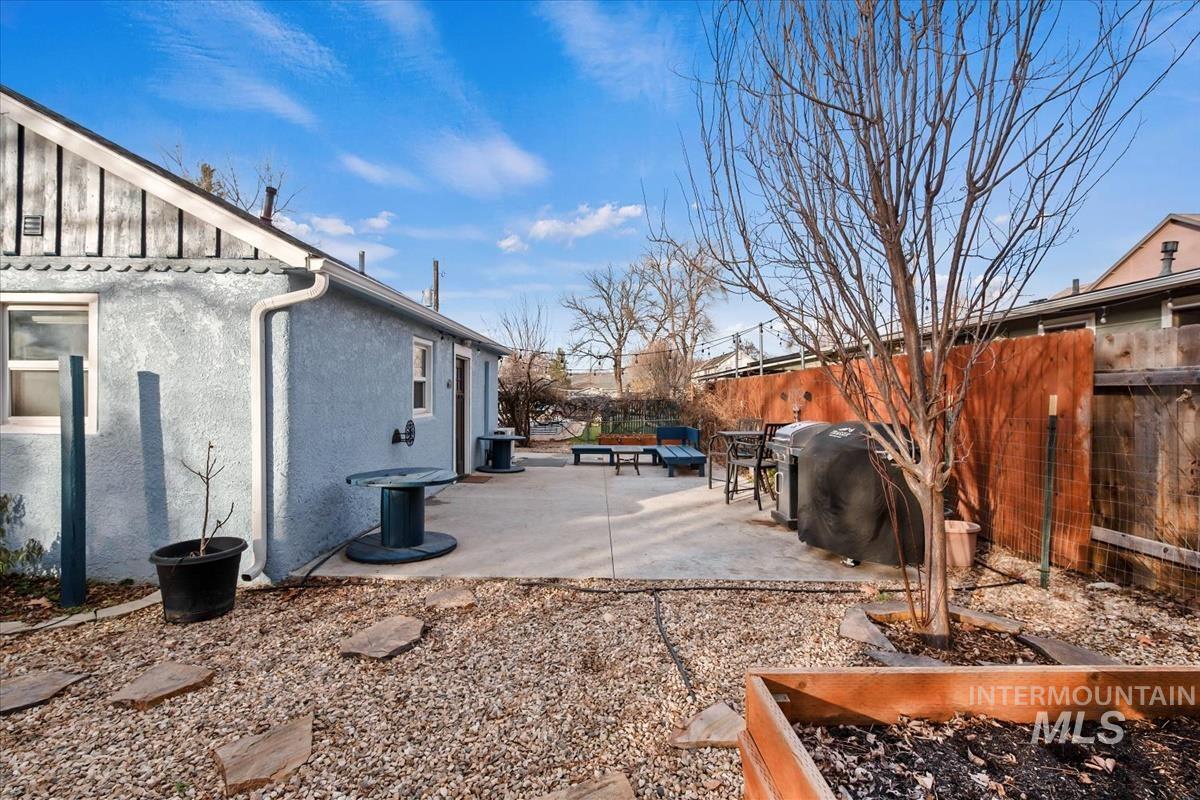 2837 Ona Street Boise, ID 83705 - Photo 6 of 26 View of home's exterior with a fenced backyard, a patio, stucco siding, and board and batten siding