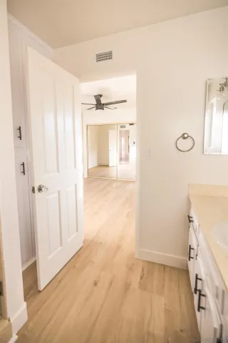 a dining room with furniture potted plants and wooden floor
