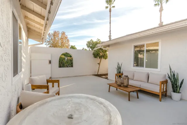 a living room with furniture and a potted plant