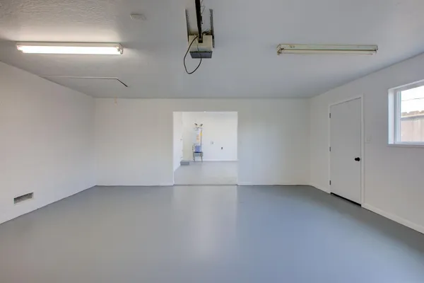 an empty room with a empty space and windows