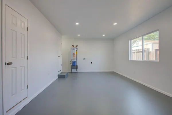 an empty room with windows and closet