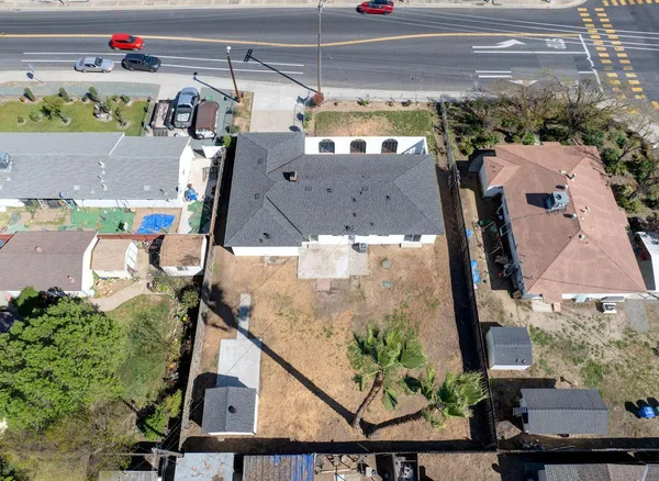 an aerial view of houses with a yard