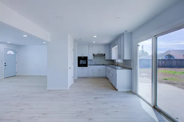 a view of a kitchen with a sink and cabinets