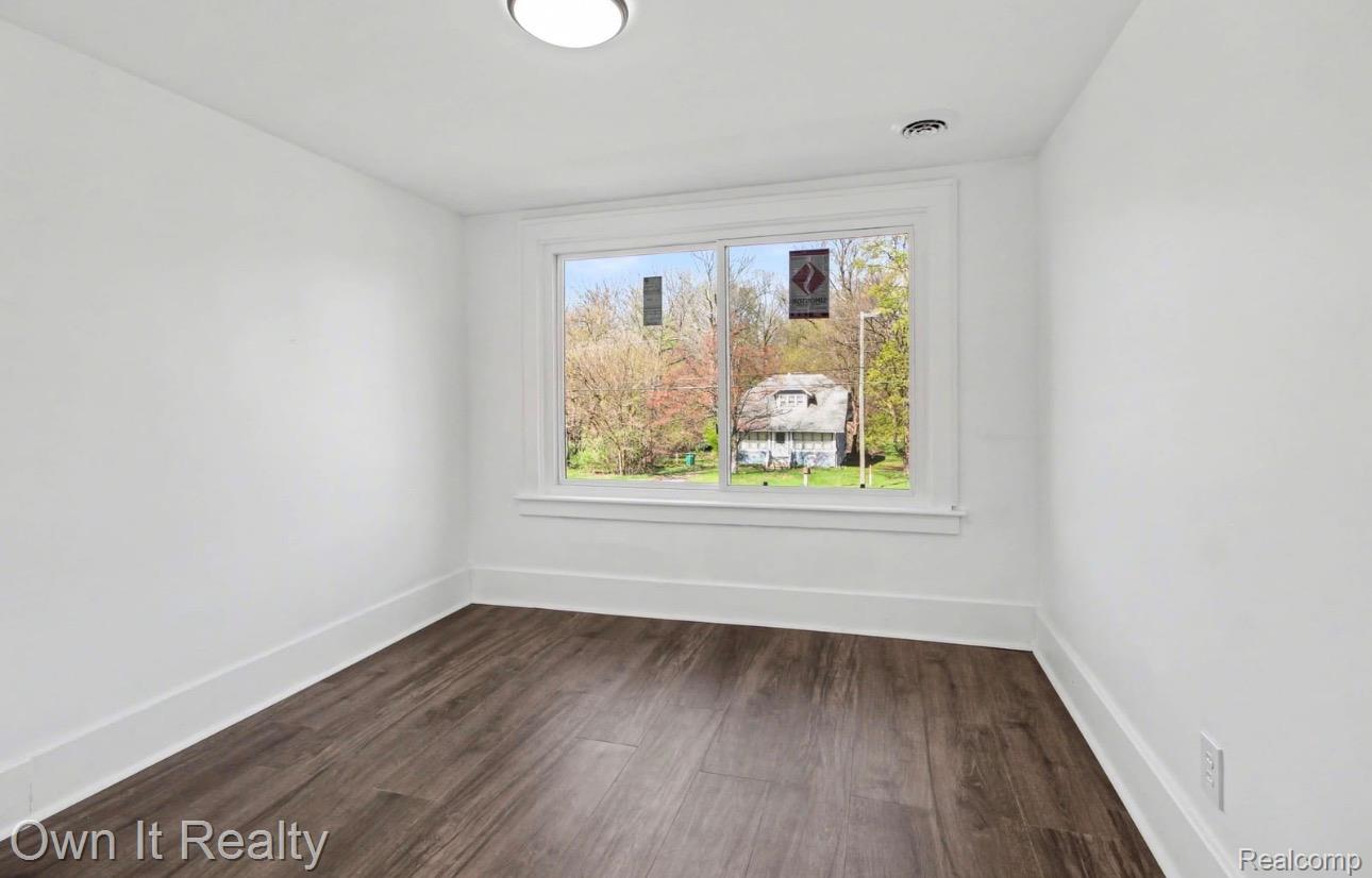 6023 Wayne Road Romulus, MI 48174 - Photo 19 of 25 Unfurnished room featuring baseboards and dark wood-style floors