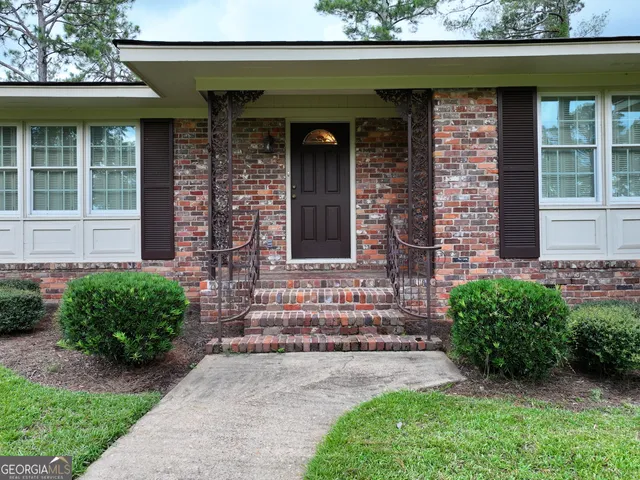 a front view of a house with garden