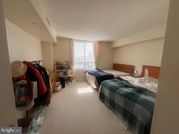 a bedroom with bed and a closet