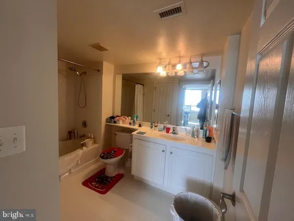 a bathroom with a tub sink and mirror