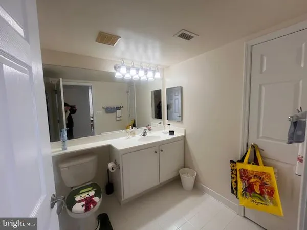 a bathroom with a sink mirror and vanity