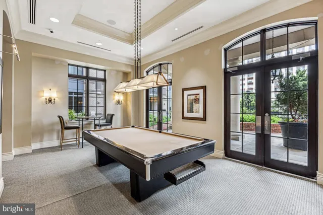 a room with pool table and windows