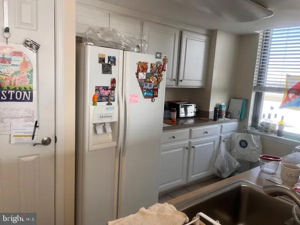 a kitchen with stainless steel appliances a refrigerator and a window