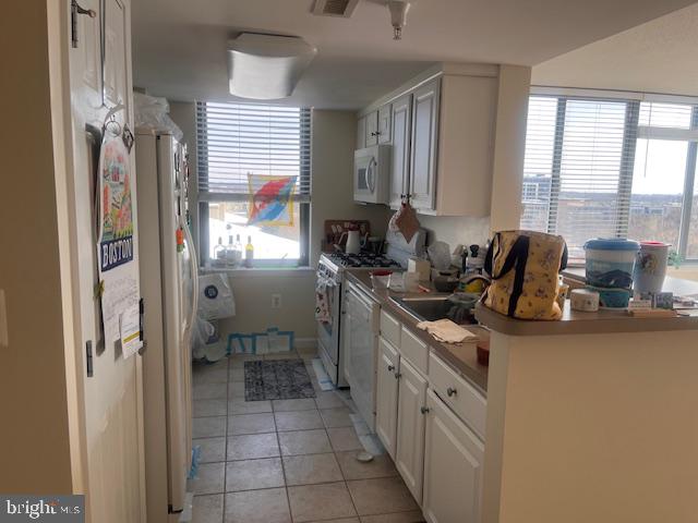 11710 Old Georgetown Road, Unit 602E Rockville, MD 20852 - Photo 10 of 22 a kitchen with stainless steel appliances kitchen island granite countertop a refrigerator and a sink