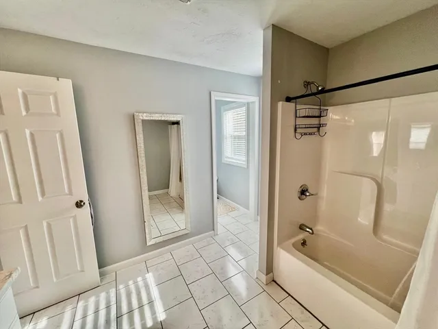 a bathroom with a bathtub and a shower