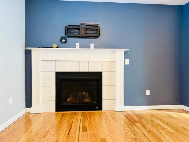 a bedroom with a fireplace and a table