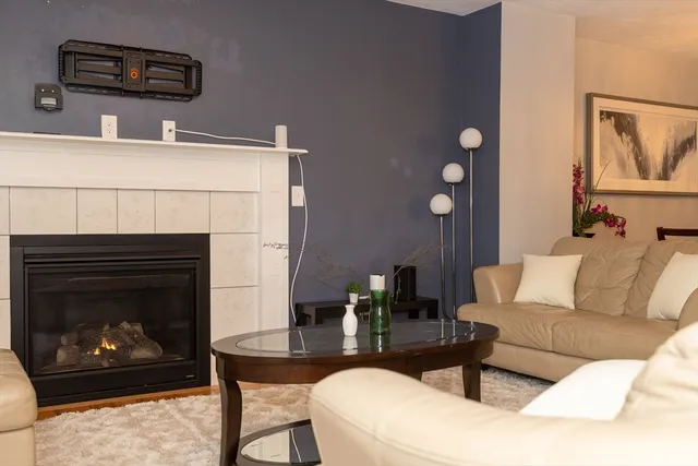 a living room with furniture a fireplace and window