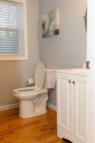 a white toilet sitting next to a bathroom sink