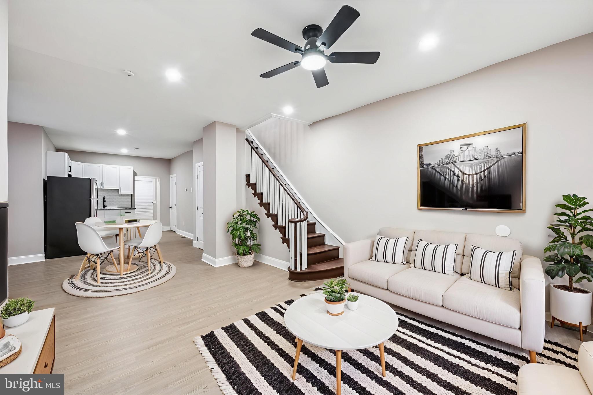 5614 Haverford Avenue Philadelphia, PA 19131 - Photo 1 of 19 a living room with furniture and a dining table with wooden floor
