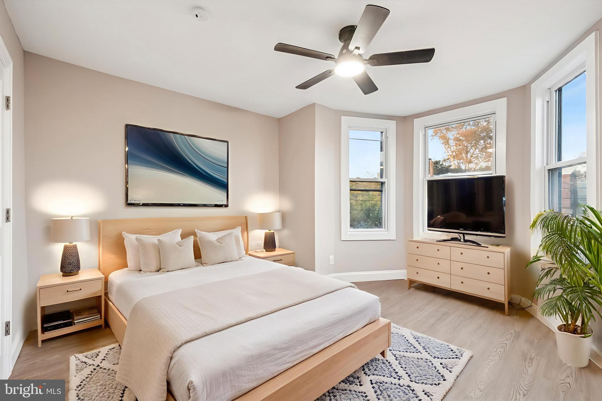 5614 Haverford Avenue Philadelphia, PA 19131 - Photo 16 of 19 a bedroom with a bed a flat screen tv and a couch