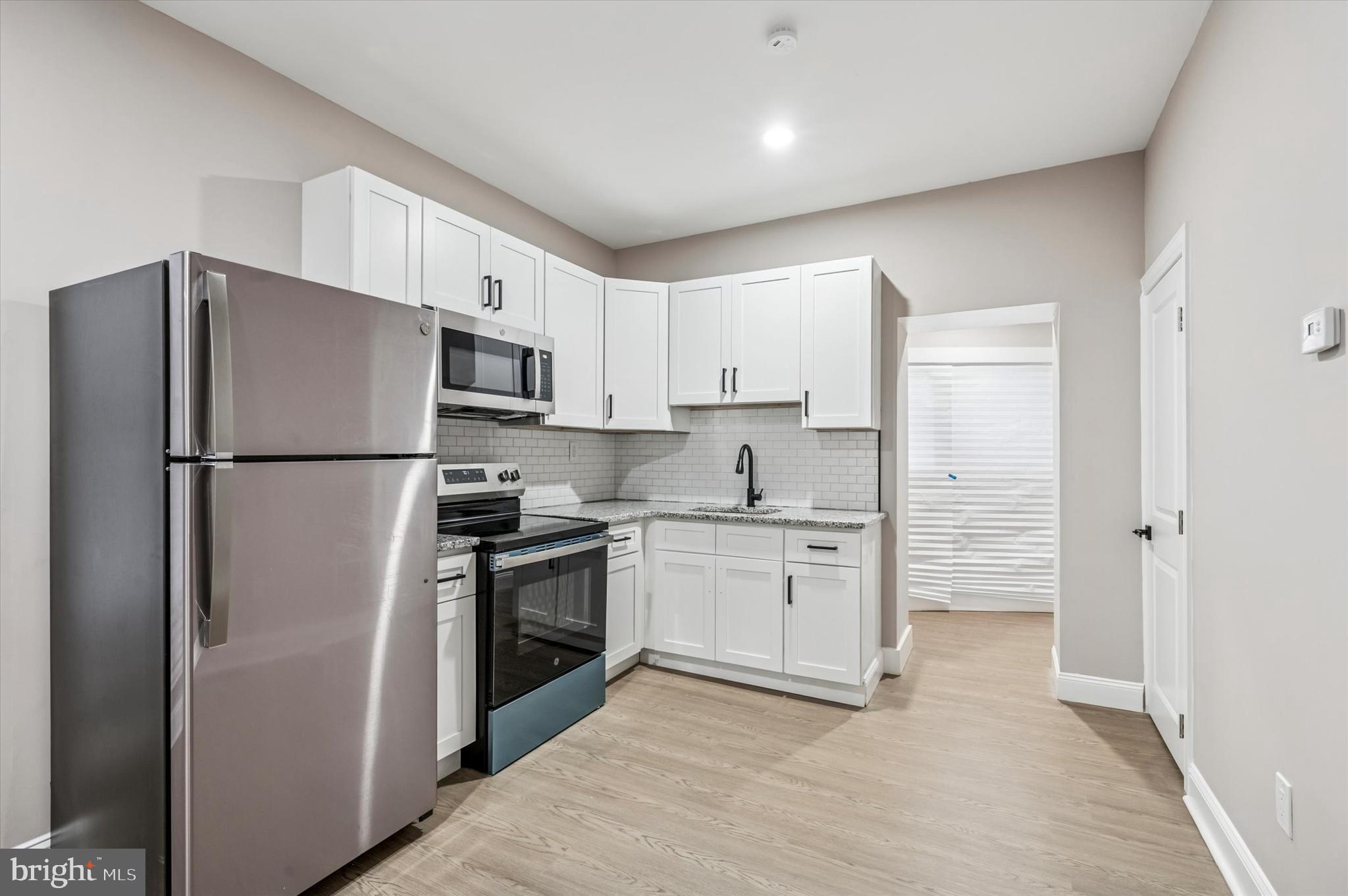 5614 Haverford Avenue Philadelphia, PA 19131 - Photo 6 of 19 a kitchen with stainless steel appliances a refrigerator sink and stove
