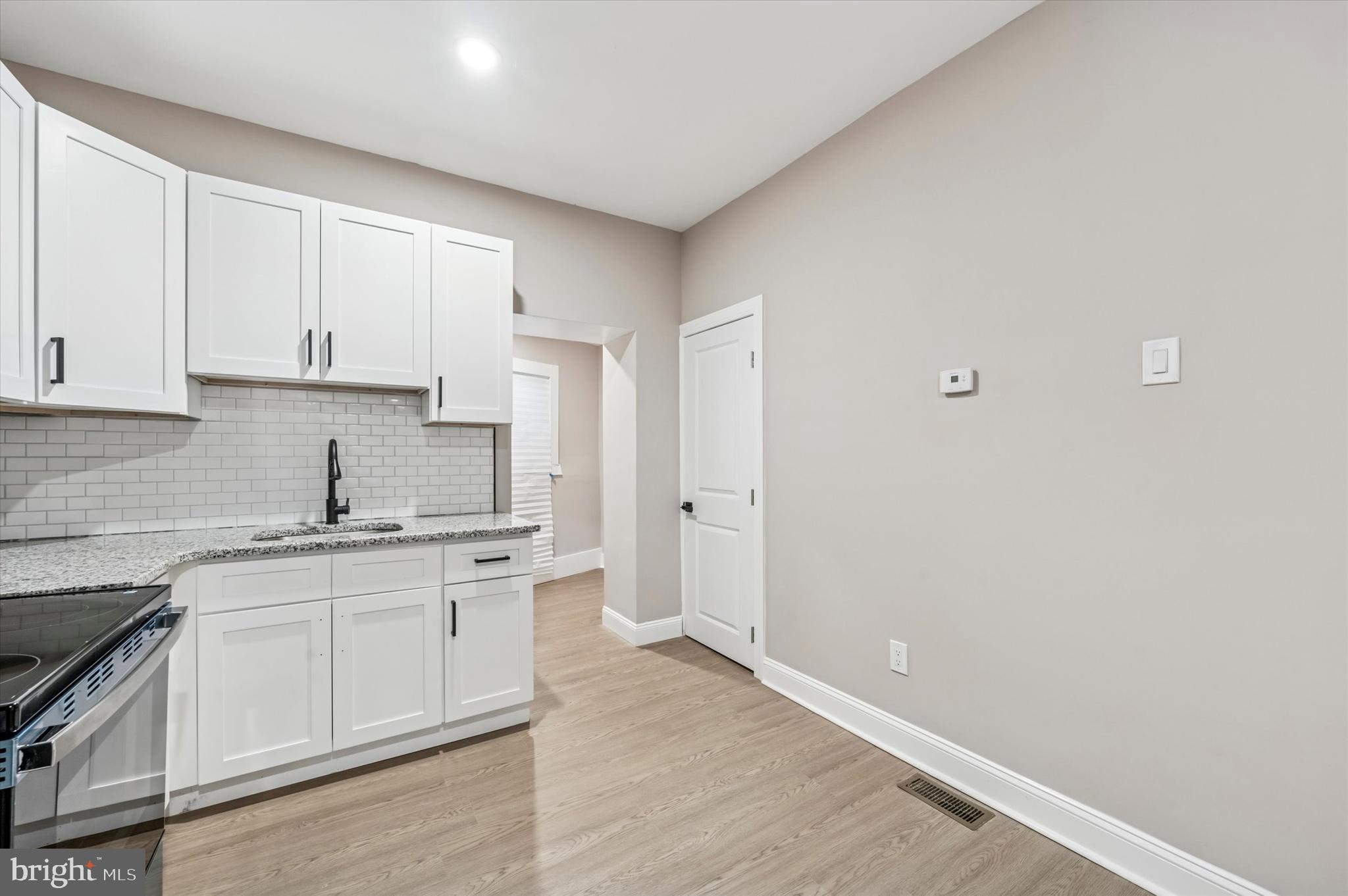 5614 Haverford Avenue Philadelphia, PA 19131 - Photo 7 of 19 a kitchen with granite countertop white cabinets and white appliances
