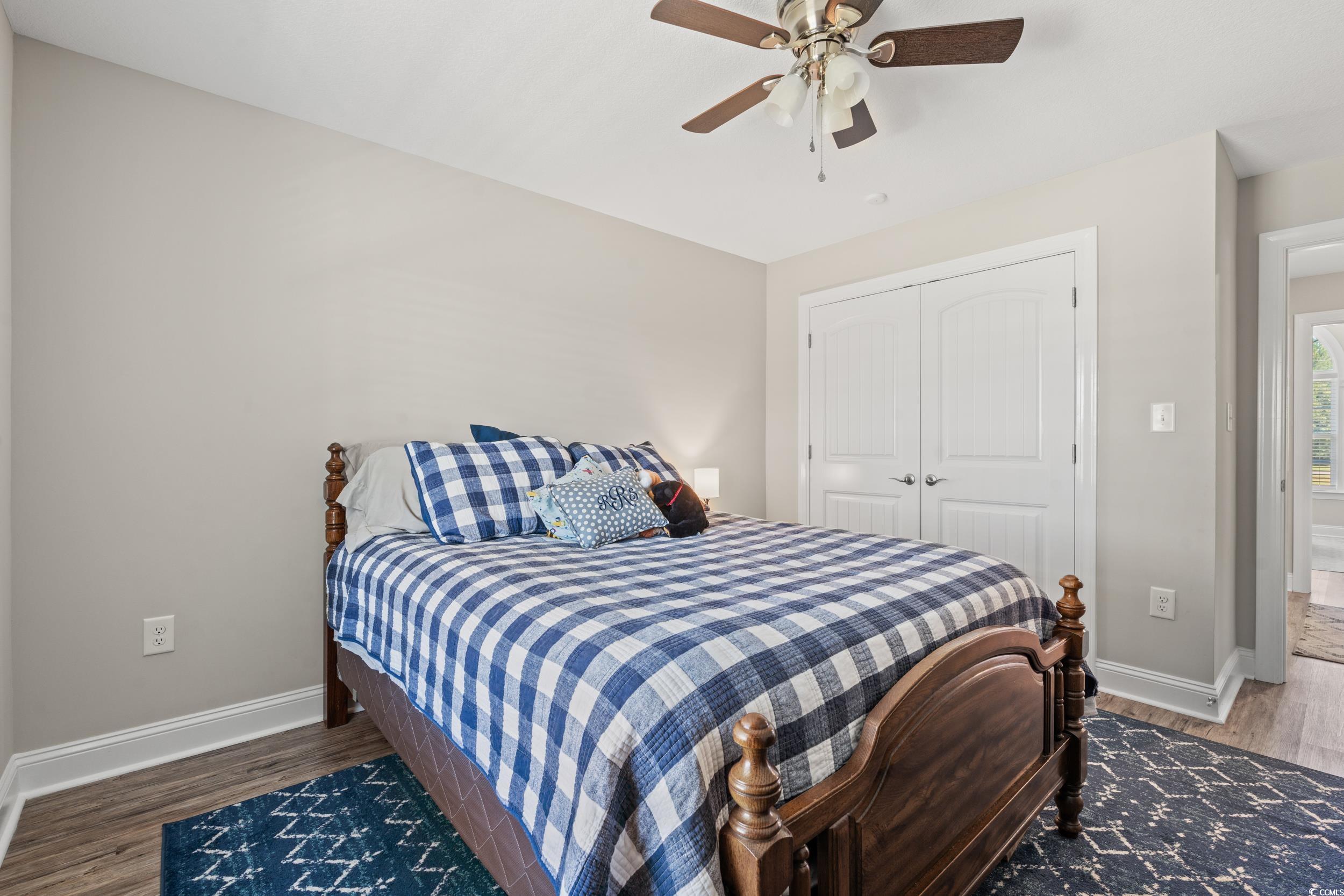 1333 Zion Road Aynor, SC 29544 - Photo 18 of 34 Bedroom featuring a closet, ceiling fan, and hardw