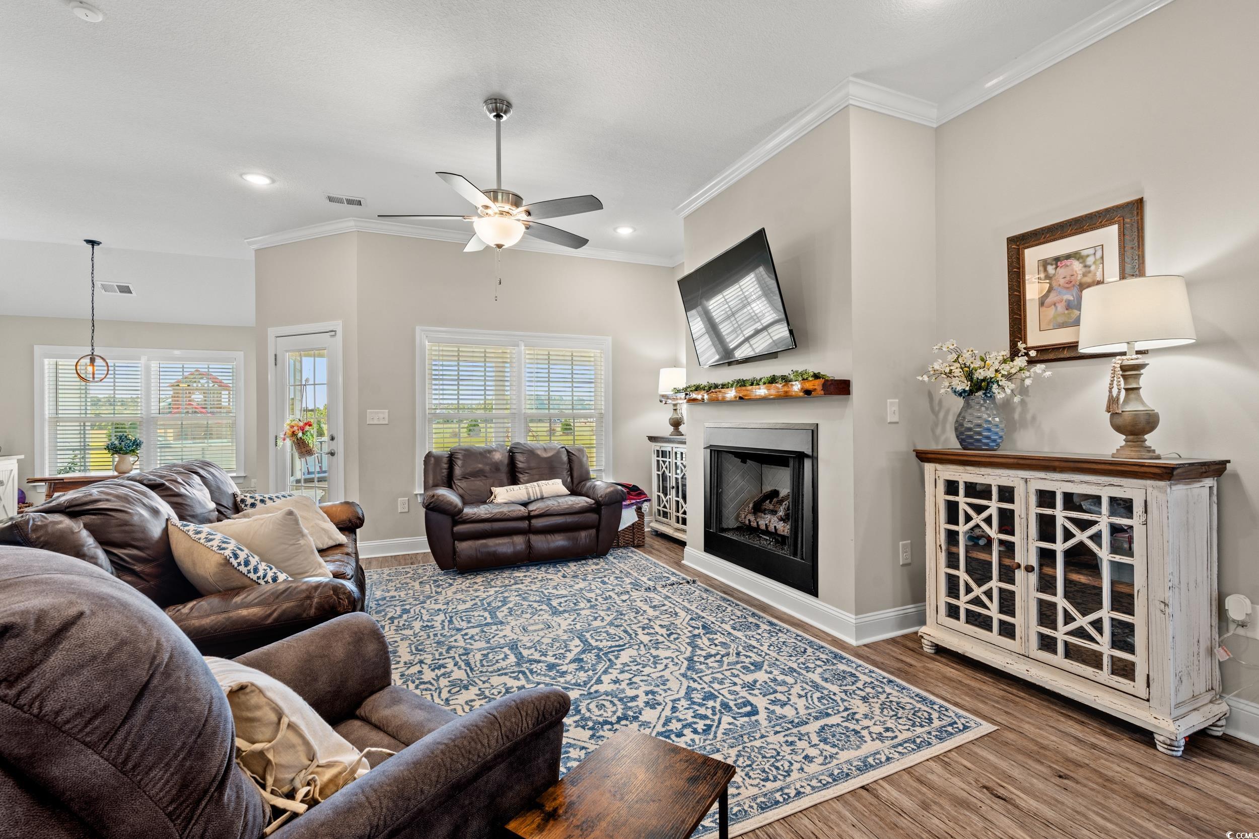 1333 Zion Road Aynor, SC 29544 - Photo 7 of 34 Living room with crown molding, hardwood / wood-st